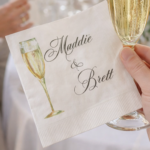 Elegant cocktail napkins with champagne glass and formal script lettering