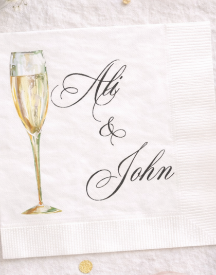 cocktail napkins with names and champagne glass for a n engagement party