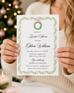 Christmas bridal shower invitation held in hands with holiday décor