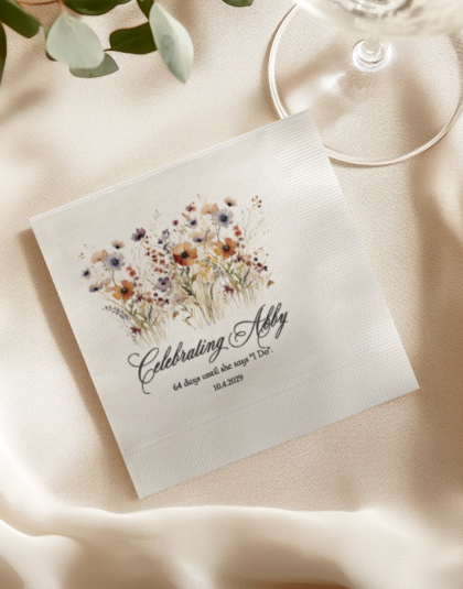 Personalized floral bridal shower cocktail napkin displayed on a neutral linen table setting