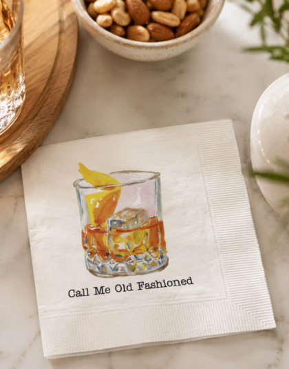Personalized Old Fashioned cocktail napkins displayed beside a whiskey cocktail